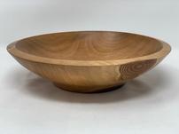 Wooden bowl in caramel color and notch grain on outer edge 202//151